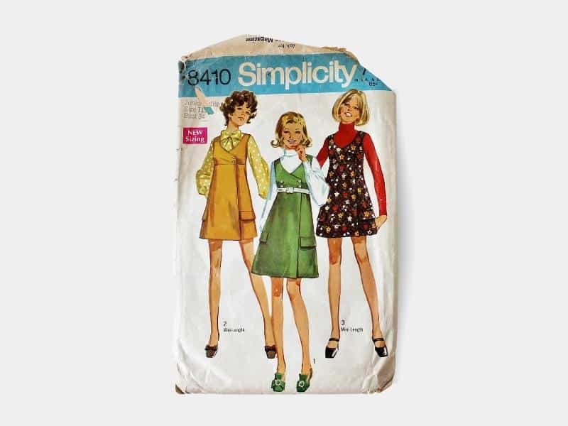 Vintage sewing pattern featuring three young women in vintage dresses