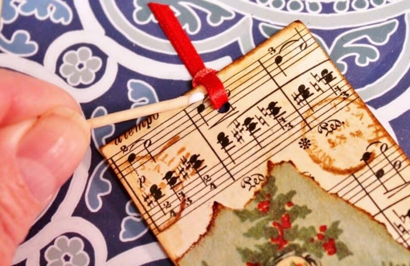 Dab a dot of tacky glue under the ribbon to hold it in place
