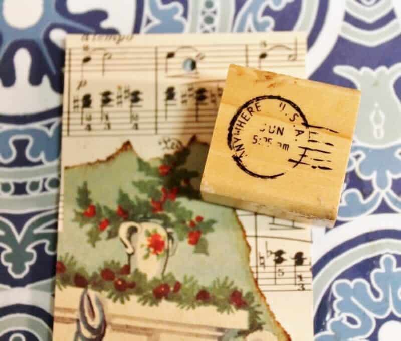 Applying a postage cancellation stamp to a vintage Christmas bookmark