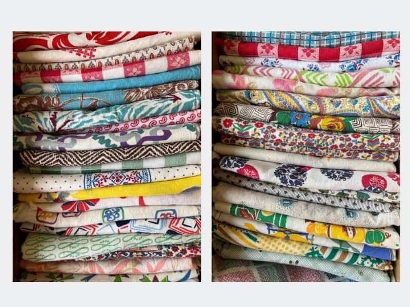 Stacks of colorful feed sack fabric at Brimfield