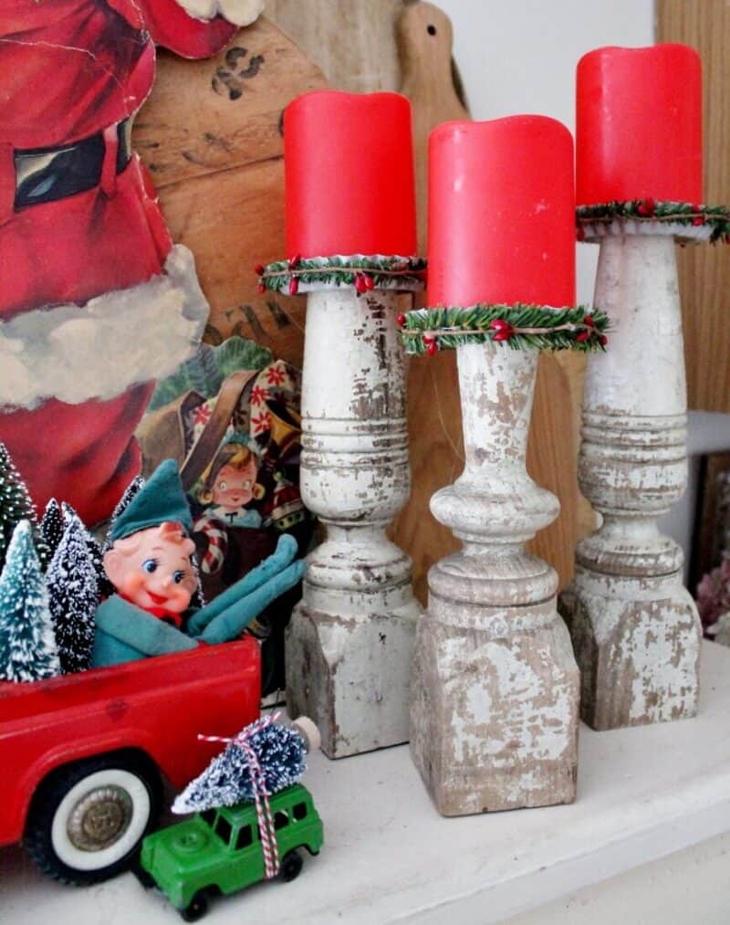 Close up of farmhouse candle holders and vintage Christmas decorations
