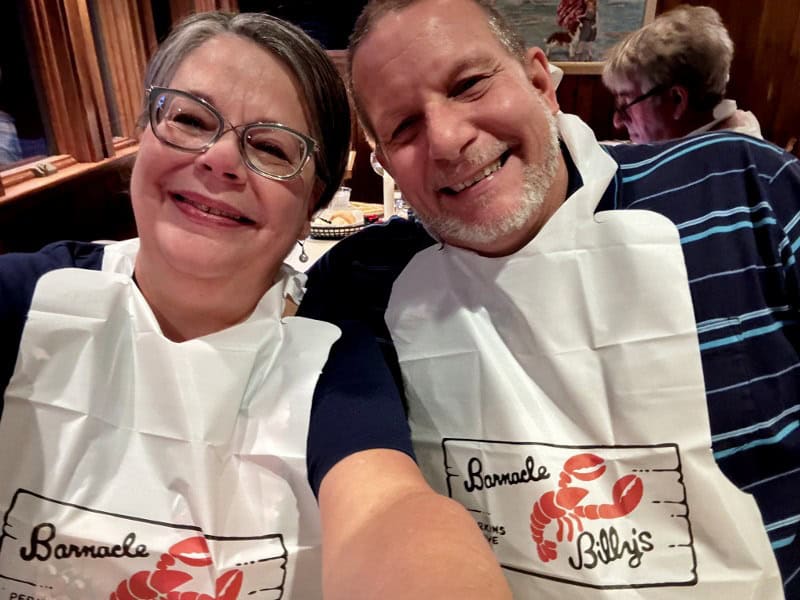 couple with lobster bibs in maine