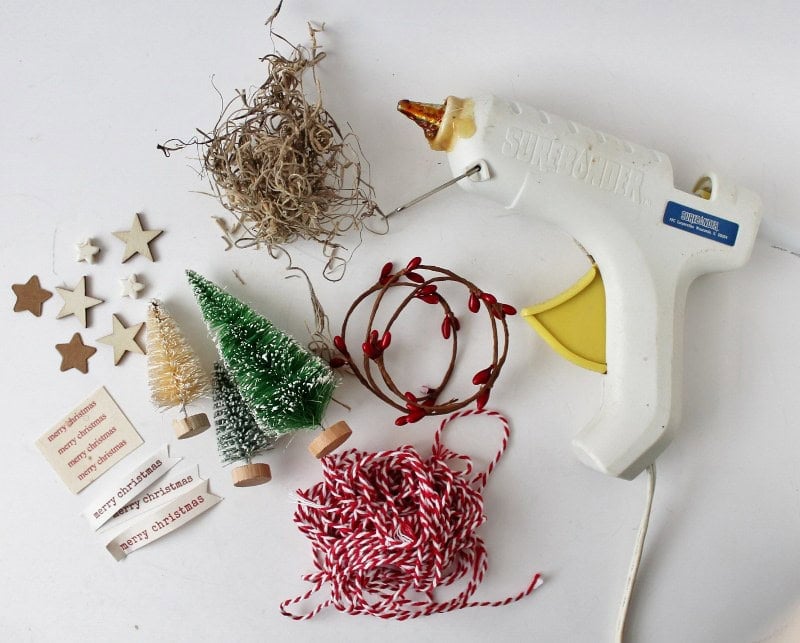 Collection of craft materials including glue gun and bottle brush trees