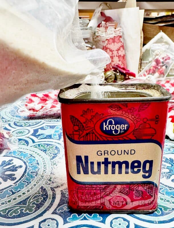 Weighting down a spice tin with sand