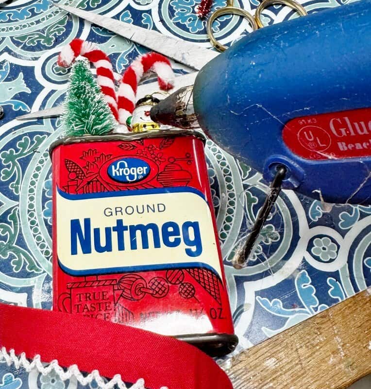gluing trim onto spice tin decoration