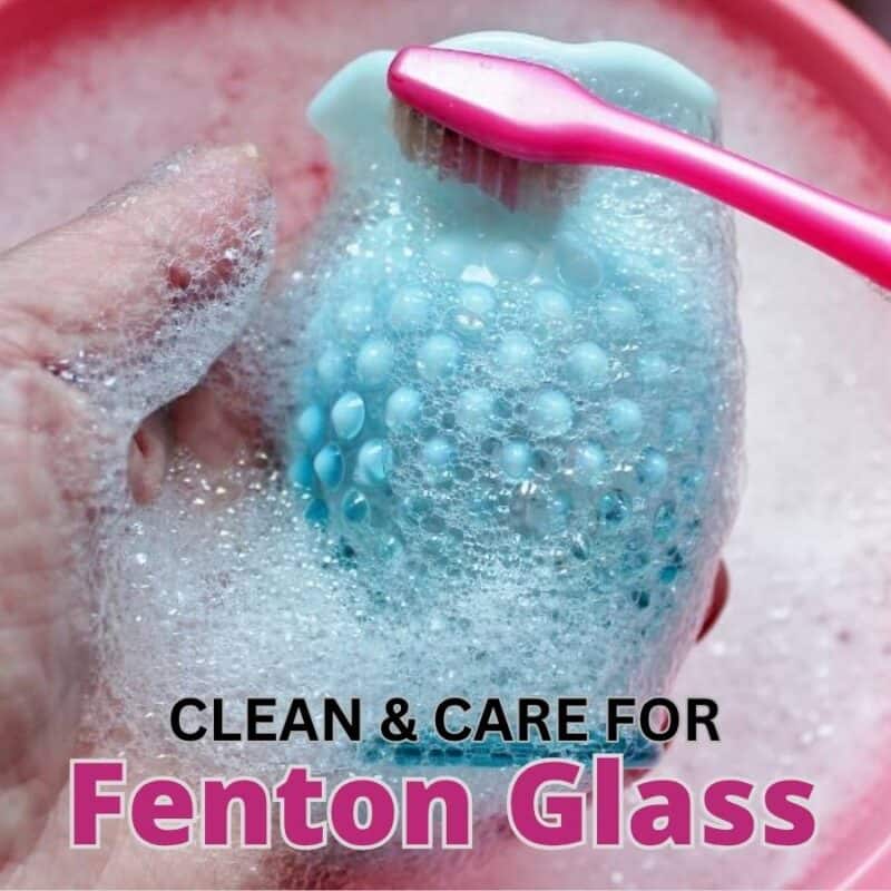 blue opalescent fenton vase being cleaned with a pink toothbrush