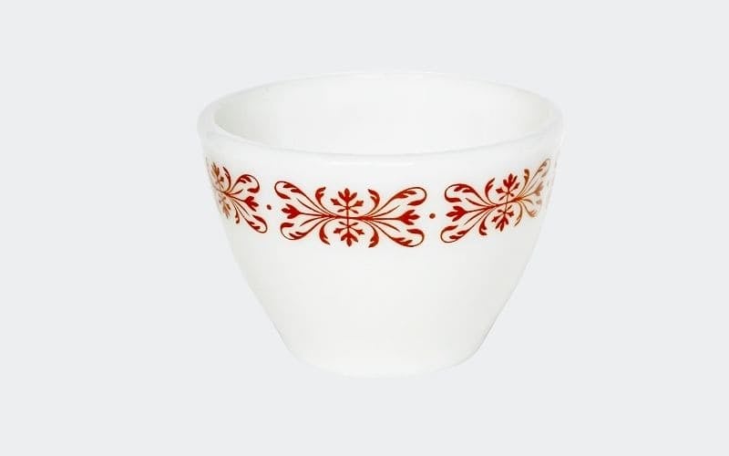 white cup with red design around edge