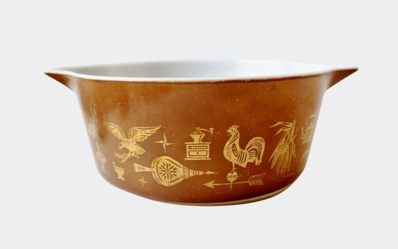 large brown casserole with gold decoration: weathervanes and roosters