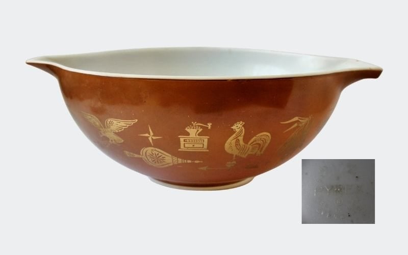 brown mixing bowl with gold decoration: weathervanes, etc