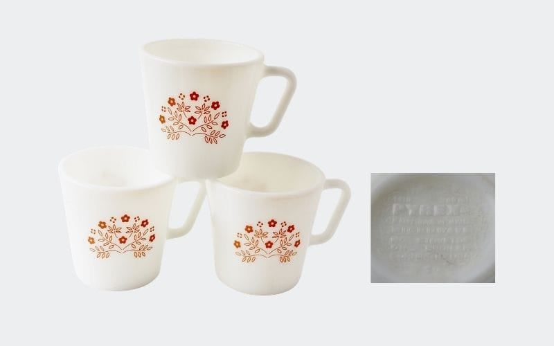 3 white glass mugs with red floral decoration on front