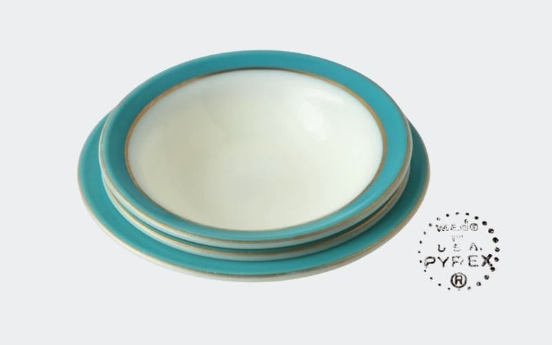 stack of white bowls with aqua blue rims