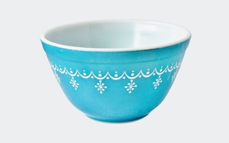 aqua blue bowl with small white snowflakes around rim