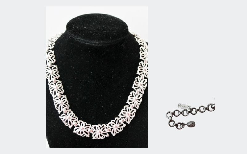 white necklace made up of square filigree pieces signed money