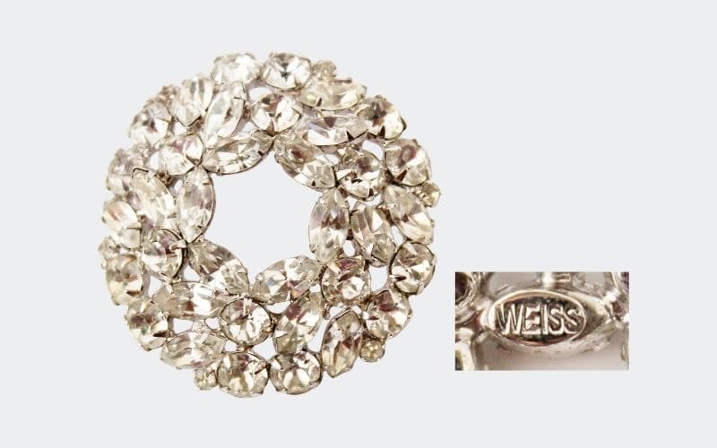 round, wreath-shaped pin with clear rhinestones