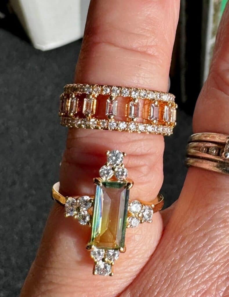 pair of rhinestone rings on a finger
