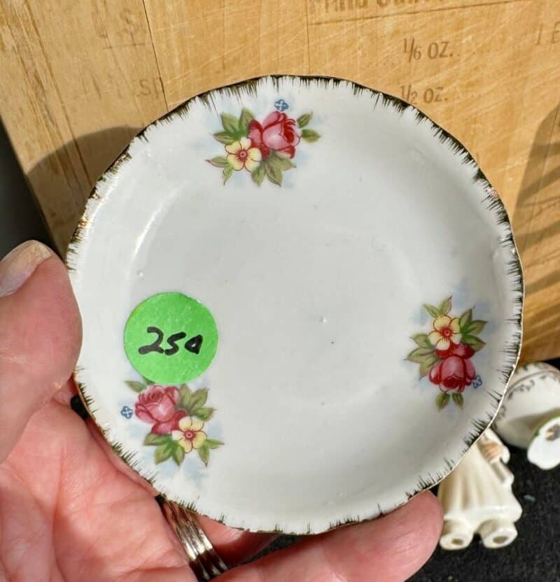 white ceramic butter pat with pink floral decoration